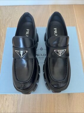 Prada Monolith leather loafer with rubber sole.